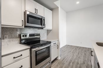 A kitchen with a stove top oven and microwave above it